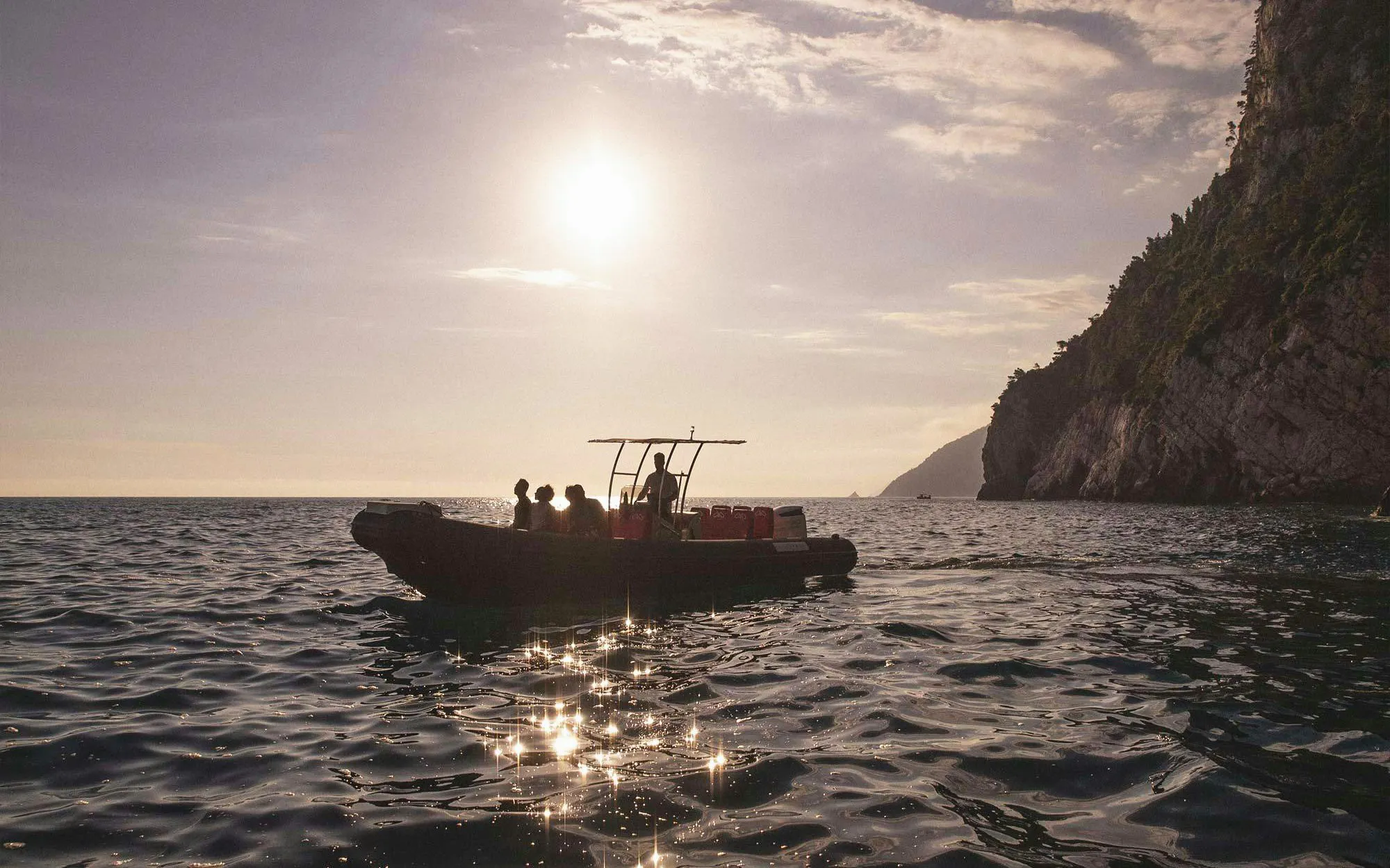Boat trip near Portovenere with cliffs and sunset in La Spezia.