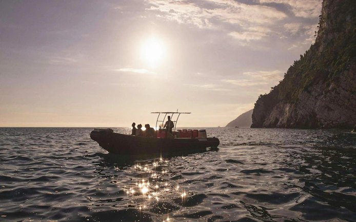 Boat trip near Portovenere with cliffs and sunset in La Spezia.