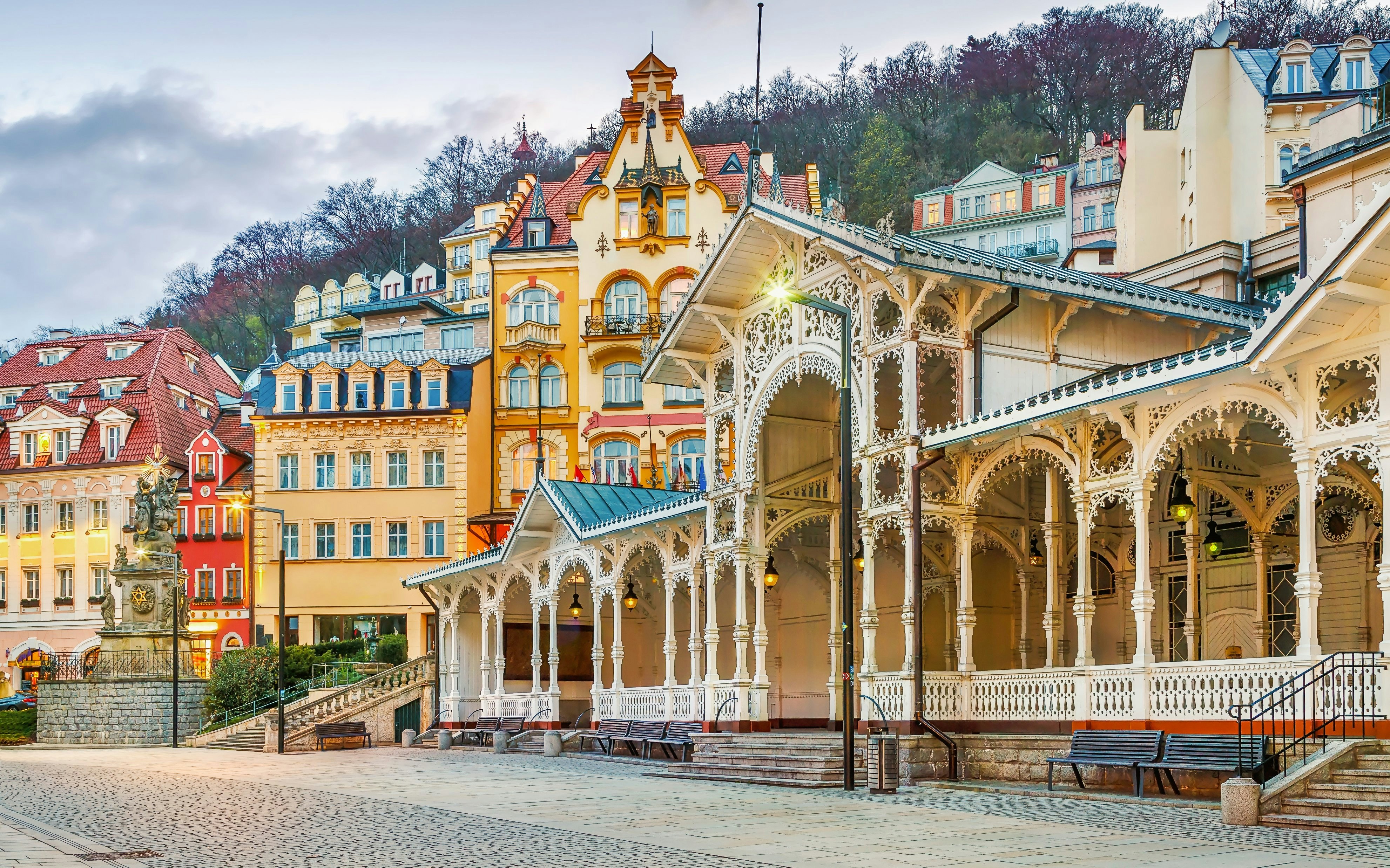Market Colonnade in Karlovy Vary with ornate wooden architecture and colorful buildings.