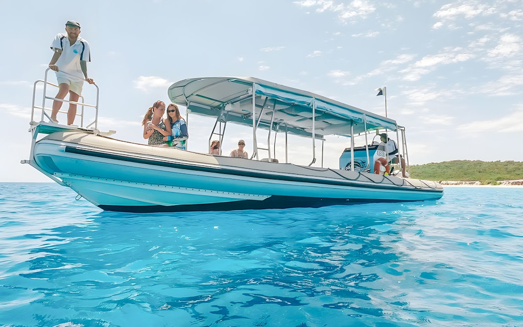 Tour boat with passengers on clear blue water in Hervey Bay.