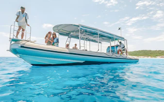 Tour boat with passengers on clear blue water in Hervey Bay.