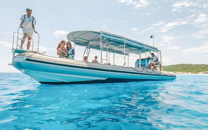 Tour boat with passengers on clear blue water in Hervey Bay.