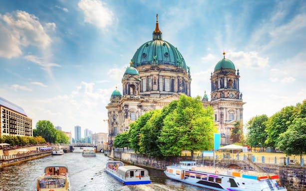 Berlin Cathedral with boats on the Spree River, part of the Deluxe Berlin car tour.