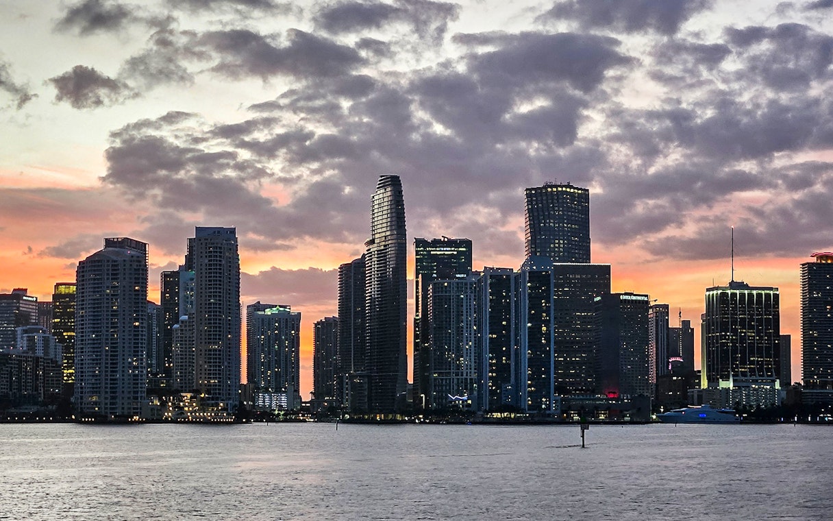Skyline of Miami at sunset viewed from Biscayne Bay during a South Beach cruise.