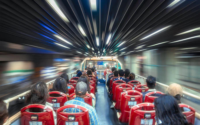Open-top bus with passengers on Hong Kong Kowloon night tour.
