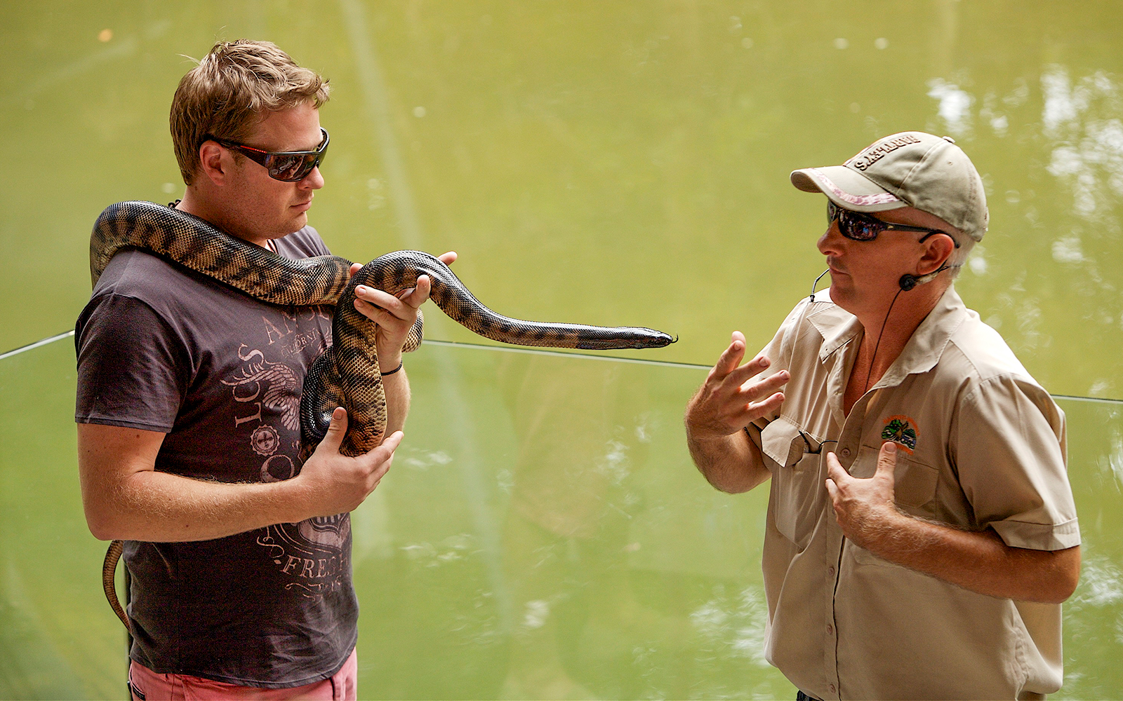 Man holding snake at Hartleys Crocodile Adventures, Queensland.