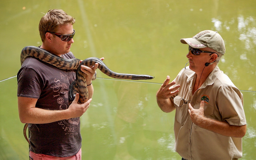 Man holding snake at Hartleys Crocodile Adventures, Queensland.