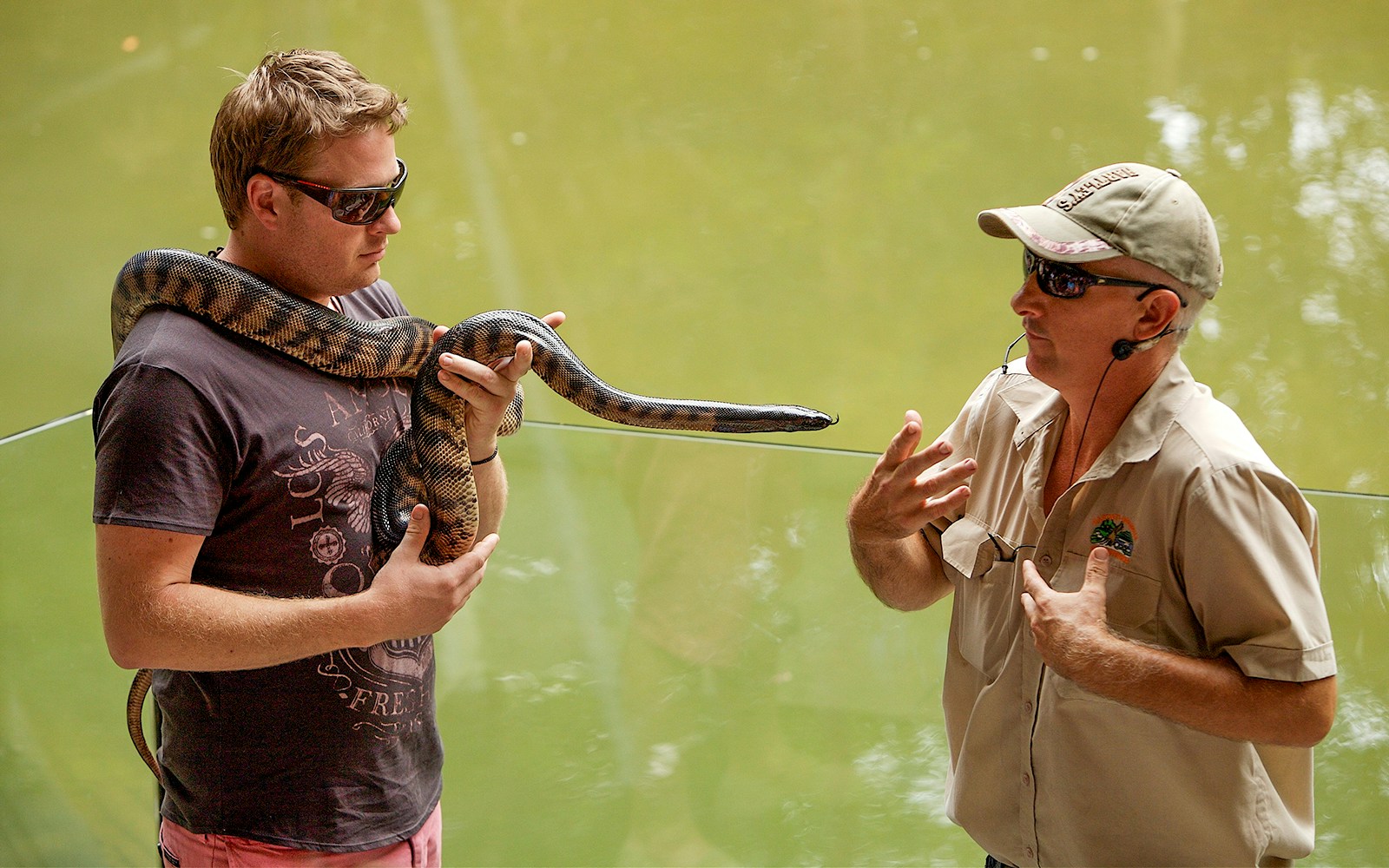 Man holding snake at Hartleys Crocodile Adventures, Queensland.
