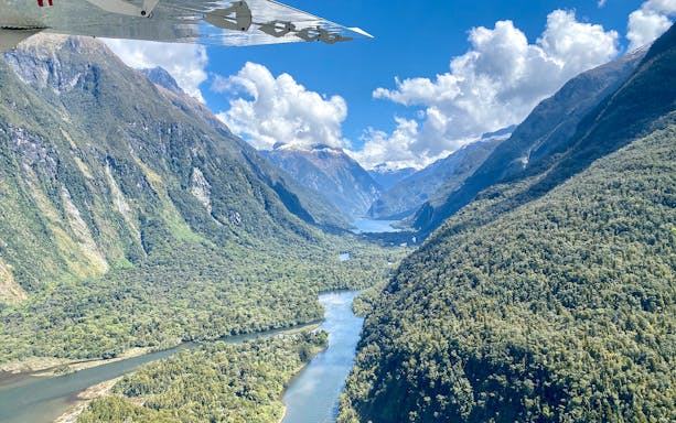 Aerial view of Milford Sound fjord and mountains during flyover tour from Queenstown.
