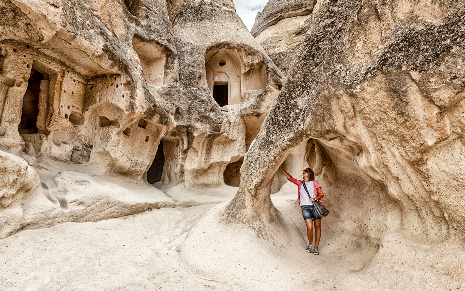 Guest exploring rock formations at Goreme Open Air Museum, Cappadocia.