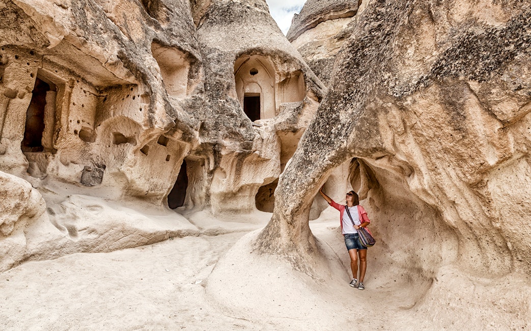 Guest exploring rock formations at Goreme Open Air Museum, Cappadocia.