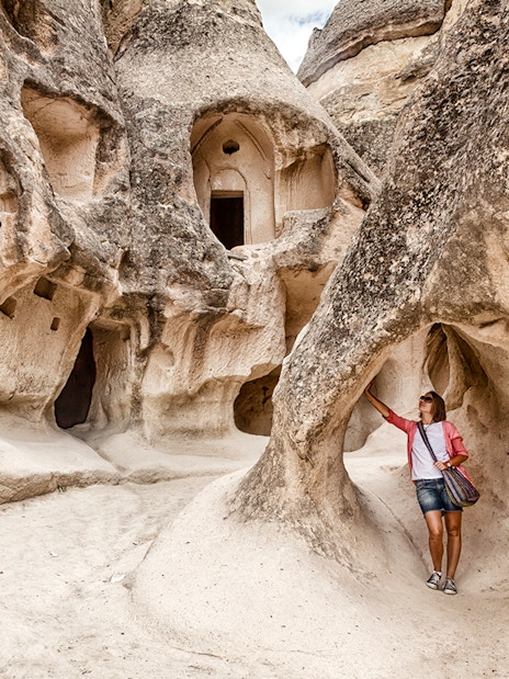 Guest exploring rock formations at Goreme Open Air Museum, Cappadocia.