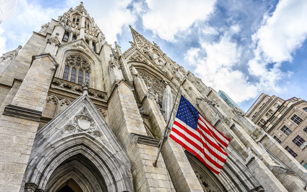 St. Patrick's Cathedral facade with American flag, New York City.