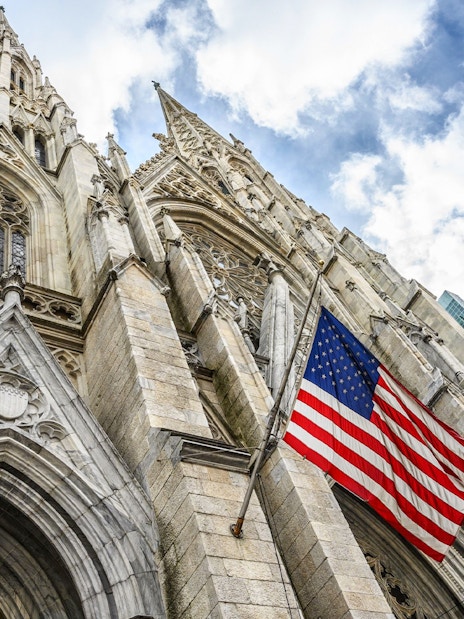 St. Patrick's Cathedral facade with American flag, New York City.