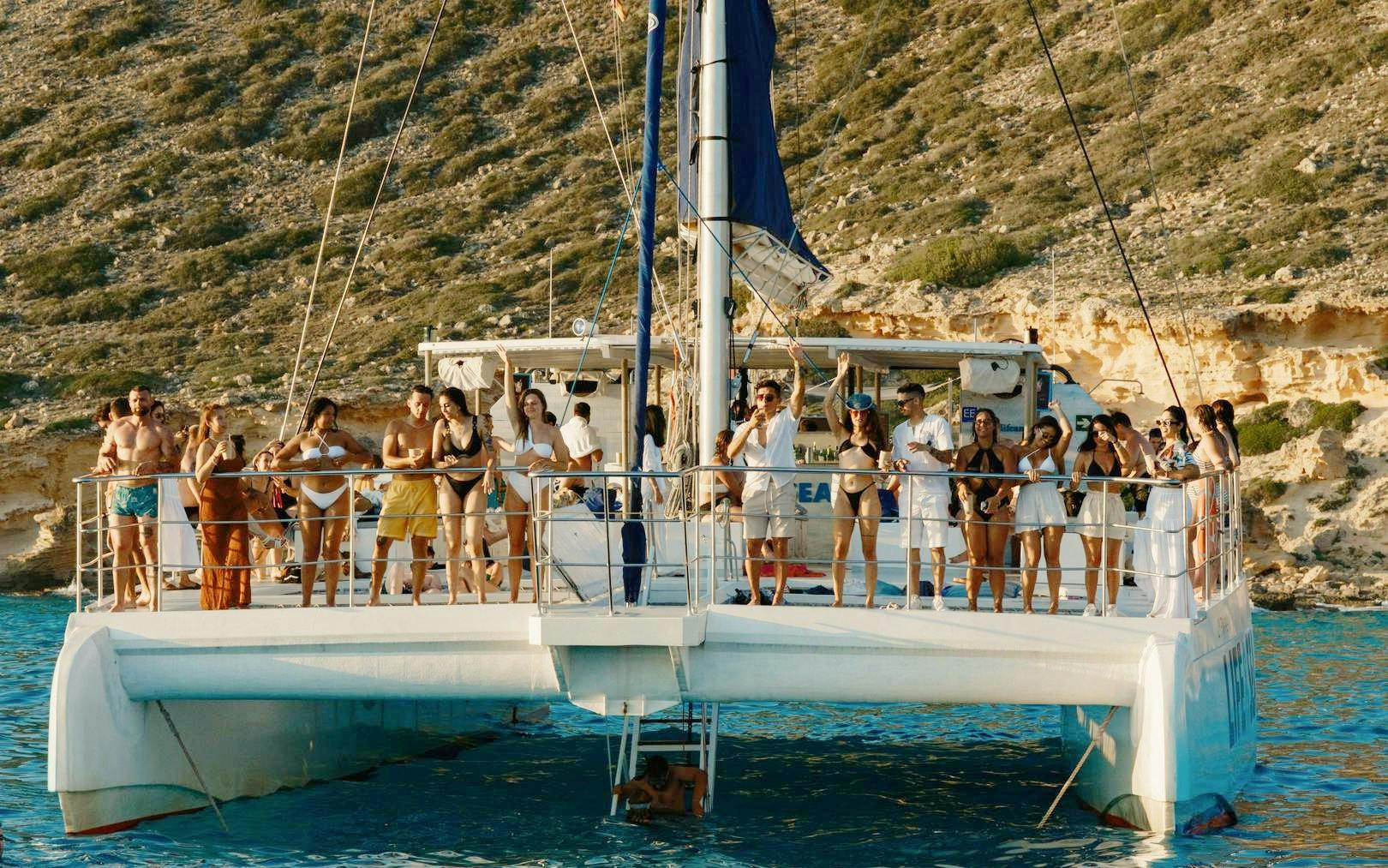 Tourists enjoying a sunset boat tour in Mallorca.