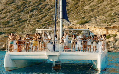 Tourists enjoying a sunset boat tour in Mallorca.