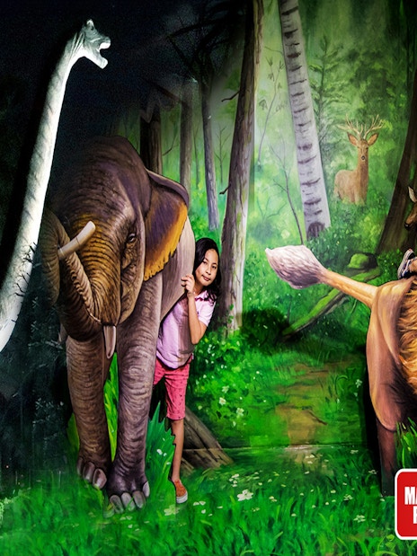 Children interacting with dinosaur and animal sculptures at Dubai Garden Glow.