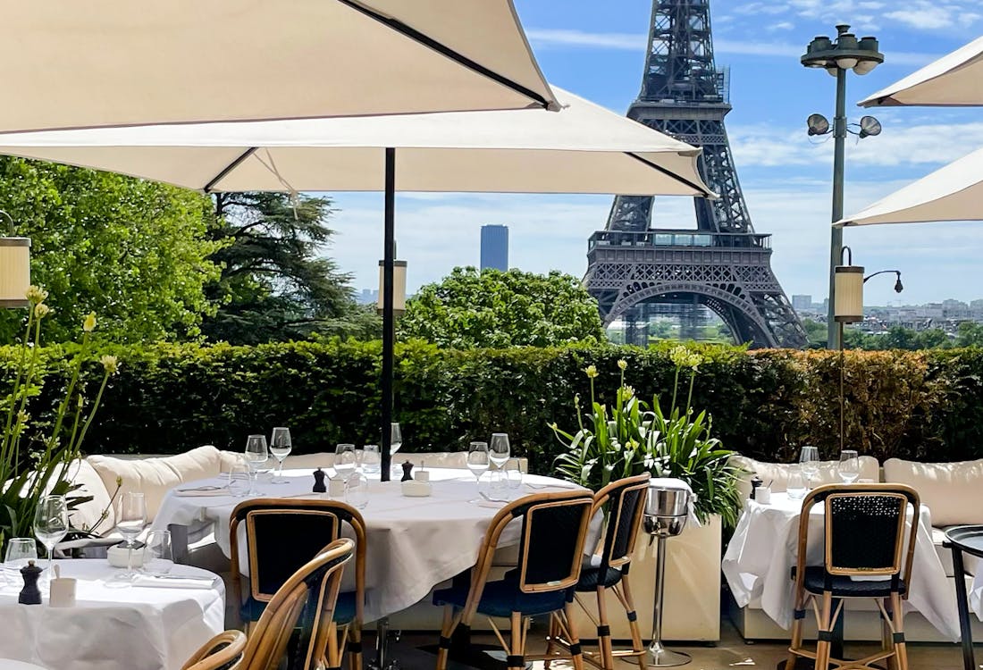 Rooftop restaurant view with Eiffel Tower in the background, Paris.