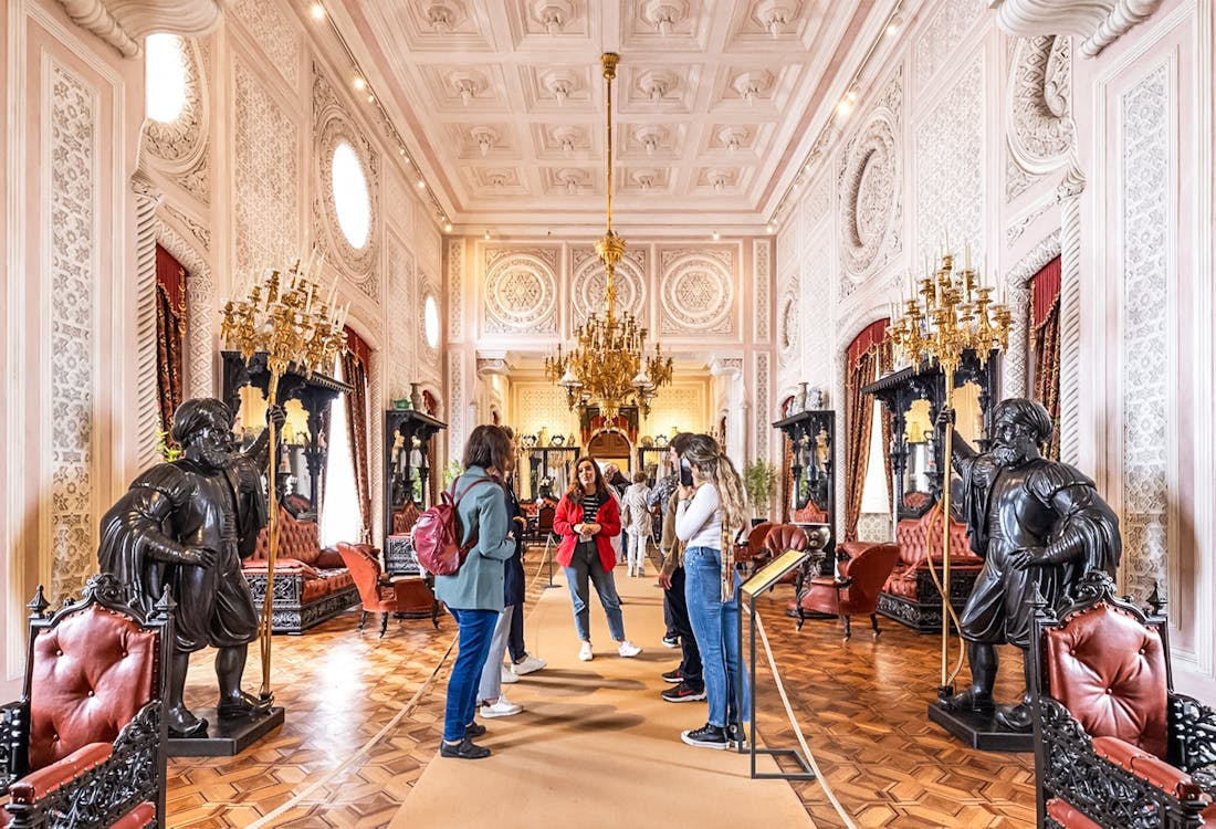 tourists exploring interiors of pena palace during a guided tour