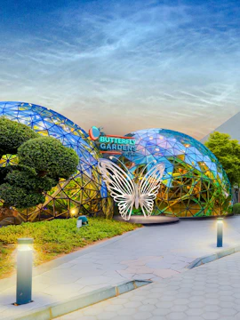Butterfly Gardens entrance with geometric dome and illuminated butterfly sculpture.