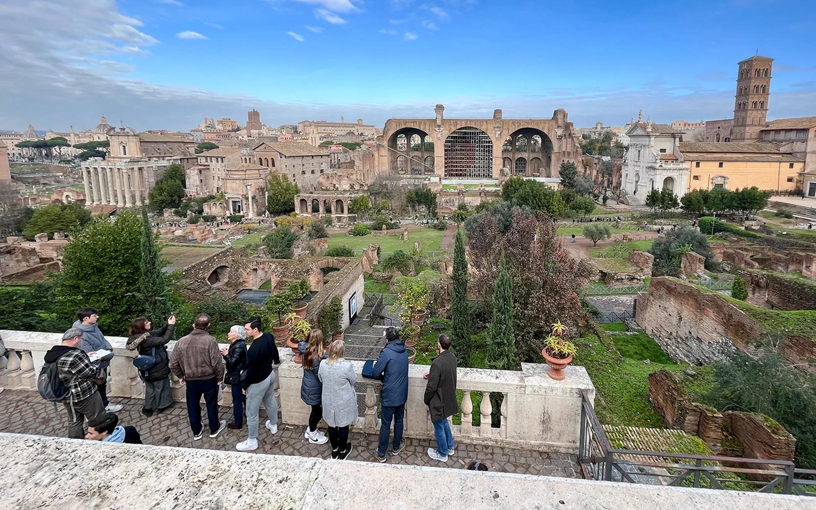 Group of tourists enjoying a guided tour of the historic Palatine Hill and Roman Forum in Rome, Italy