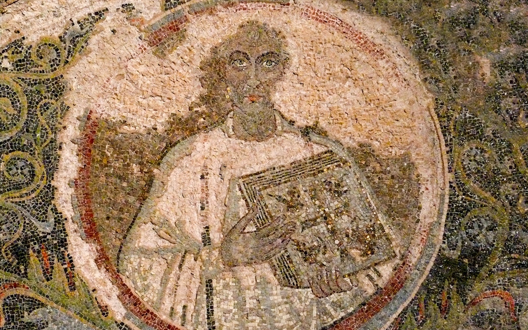 Mosaic artwork in Catacombs of San Gennaro, Naples, depicting a figure holding a book.