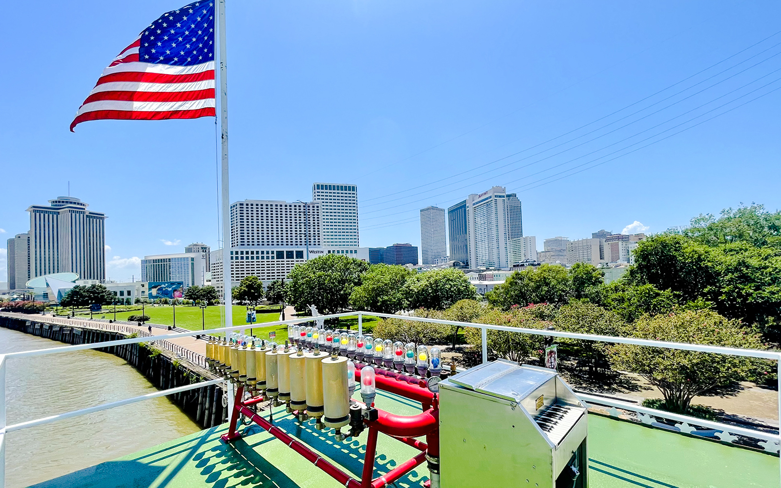 Deck view of CITY of NEW ORLEANS Riverboat with New Orleans skyline in the background.