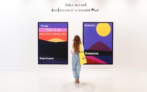 Woman viewing colorful art at Moco Museum exhibit.