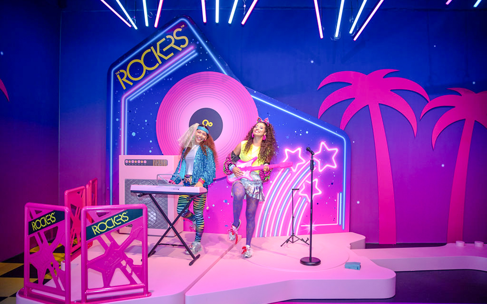 Guests enjoying Barbie The Dream Experience in Amsterdam with neon rockstar theme.