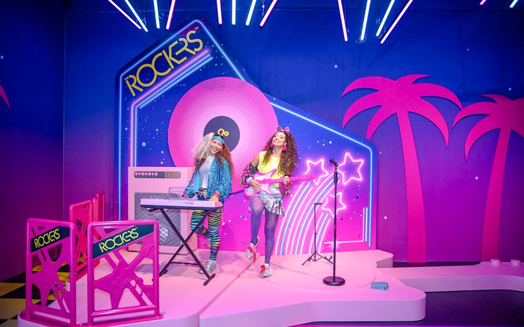 Guests enjoying Barbie The Dream Experience in Amsterdam with neon rockstar theme.