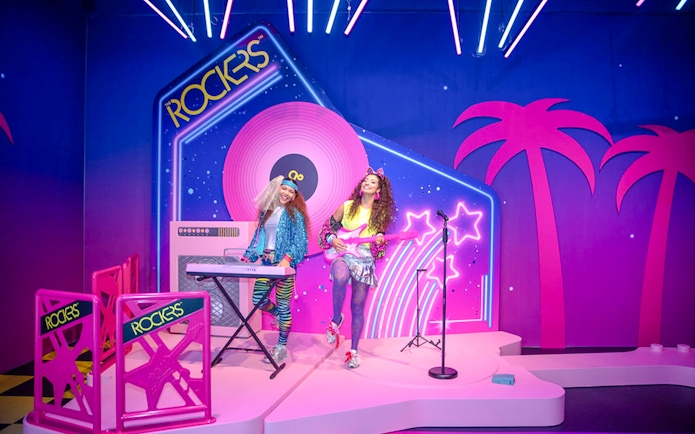 Guests enjoying Barbie The Dream Experience in Amsterdam with neon rockstar theme.