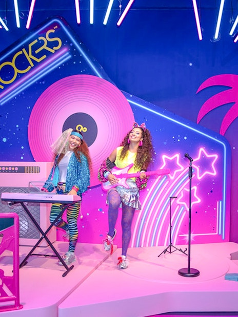 Guests enjoying Barbie The Dream Experience in Amsterdam with neon rockstar theme.