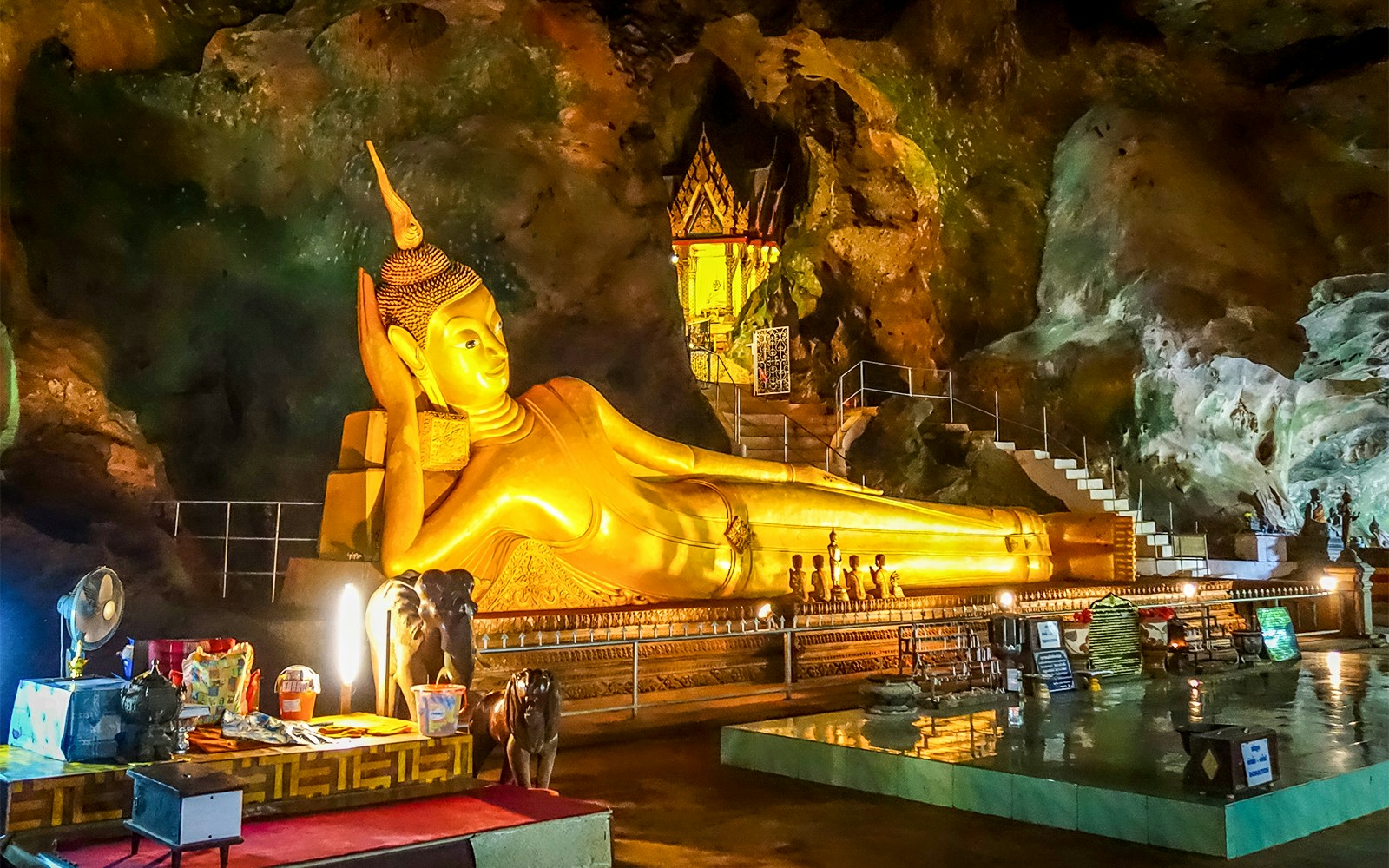Buddha statue inside Wat Suwan Kuha cave temple, Thailand.