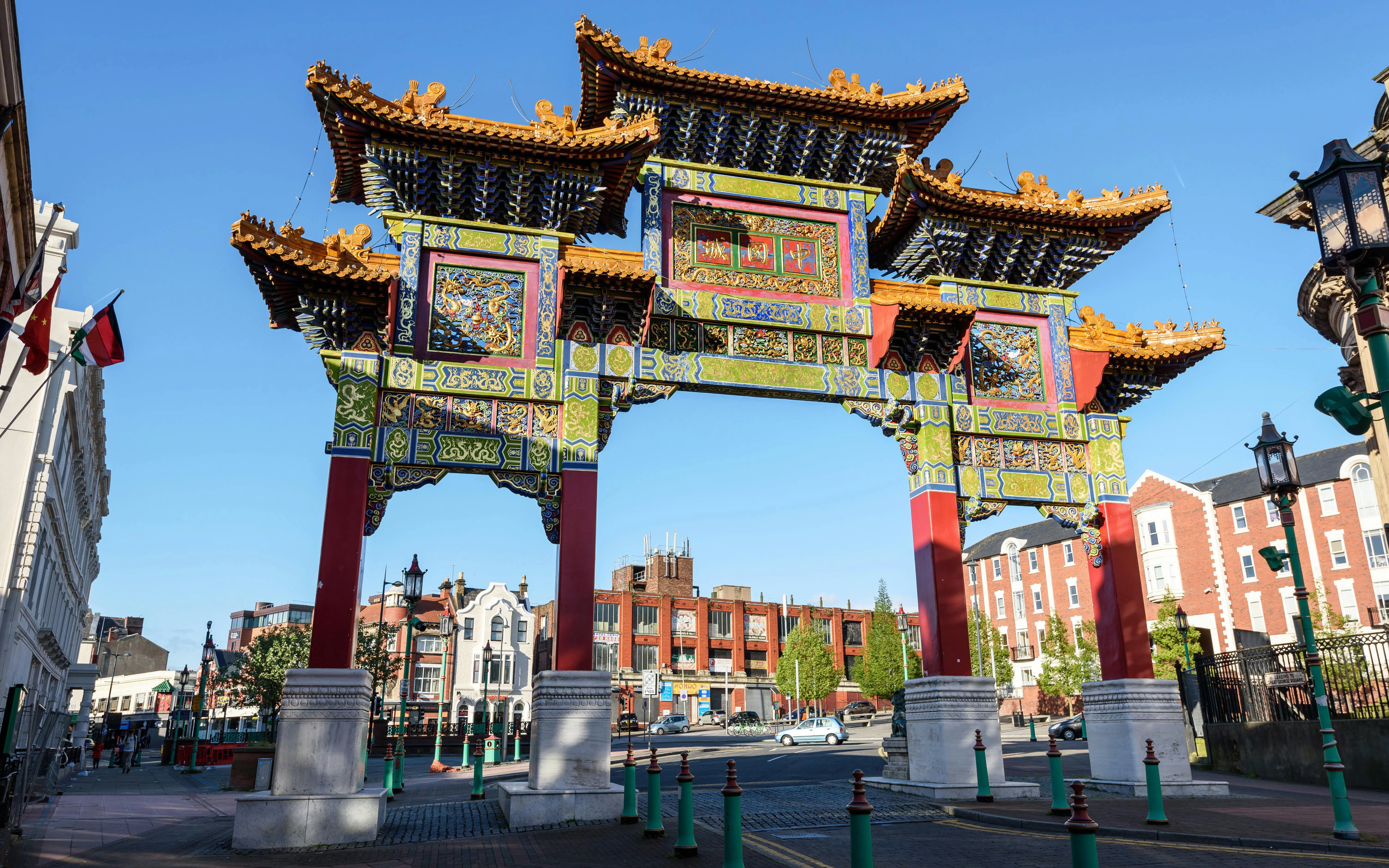Chinese Arch in Liverpool's Chinatown with surrounding buildings.
