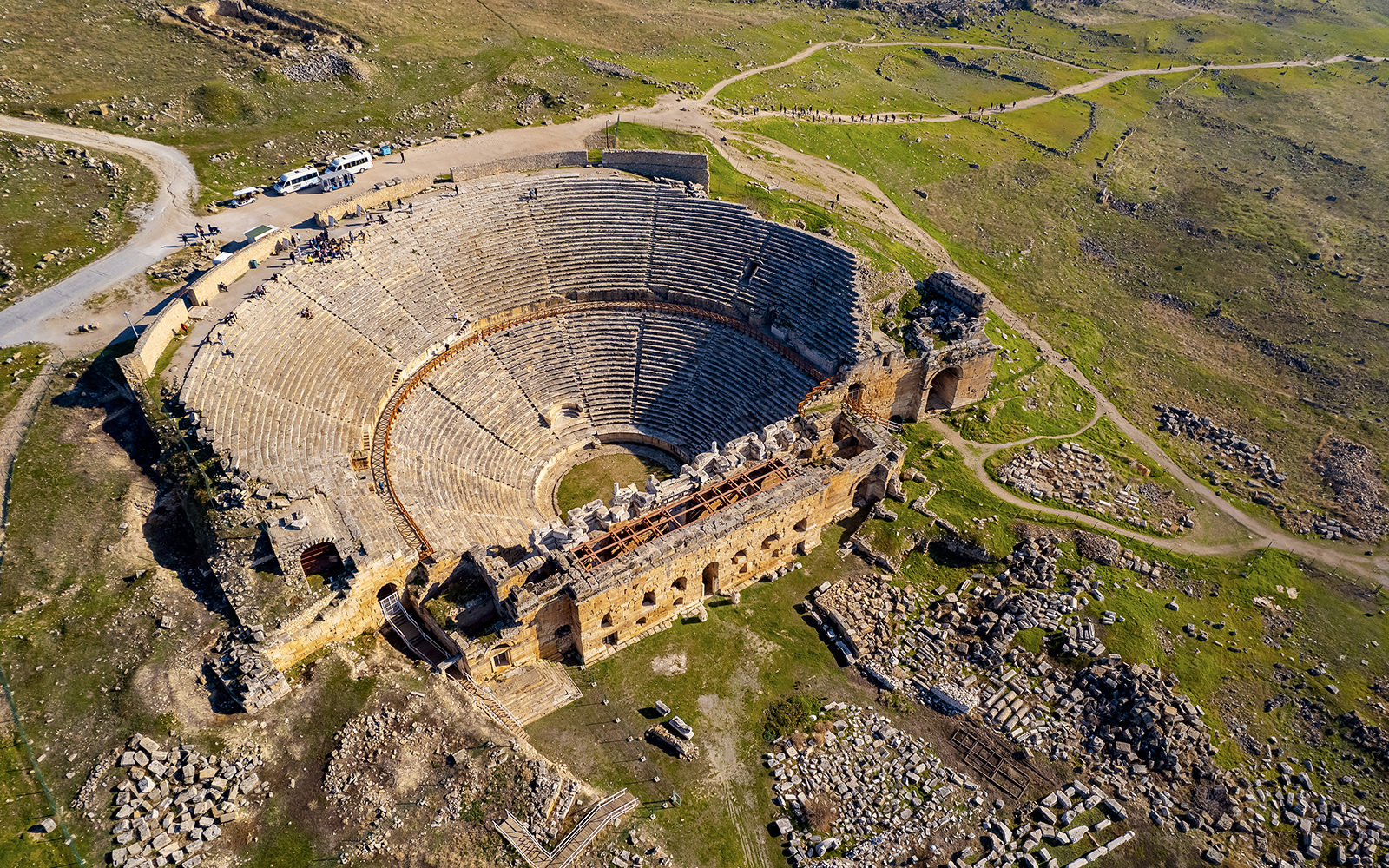 Aerial view of Hierapolis amphitheater ruins in Turkey during hot air balloon flight.