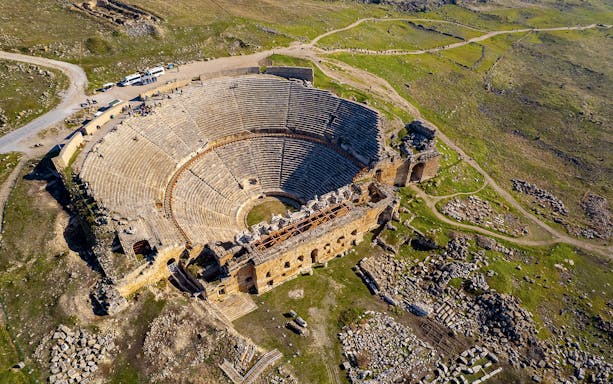 Aerial view of Hierapolis amphitheater ruins in Turkey during hot air balloon flight.