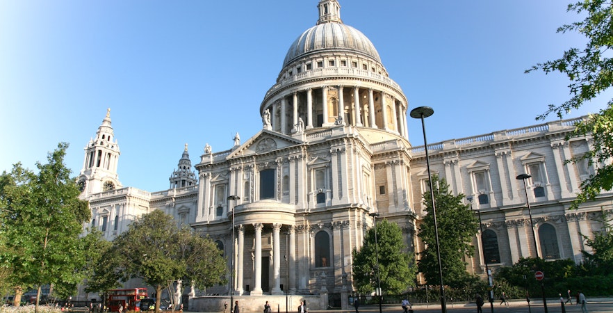 Old St Paul's Cathedral in London with its iconic dome and surrounding gardens.