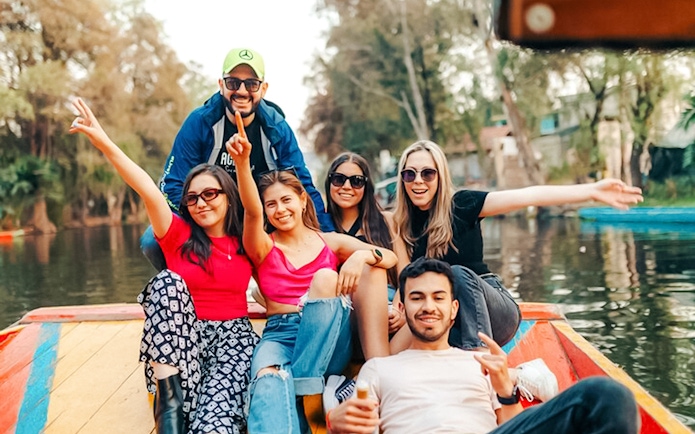 Tourists on a colorful boat enjoying the Xochimilco canals in Mexico City.