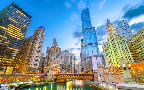 Chicago cityscape with skyscrapers along the river at dusk, Illinois, USA.
