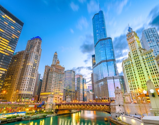 Chicago cityscape with skyscrapers along the river at dusk, Illinois, USA.