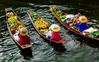 Floating market boats with fruits and goods, Pattaya city tour.