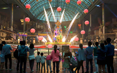 Fireworks display at Lotte World with a crowd watching inside the theme park.