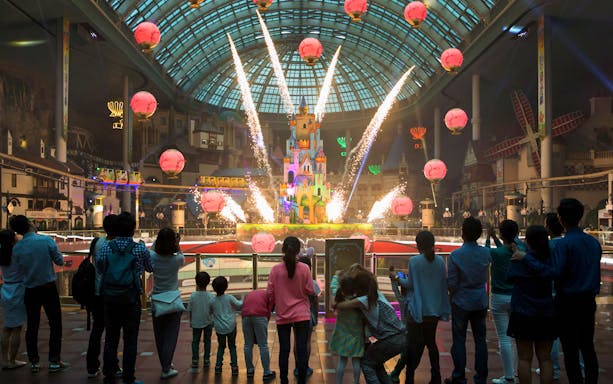 Fireworks display at Lotte World with a crowd watching inside the theme park.