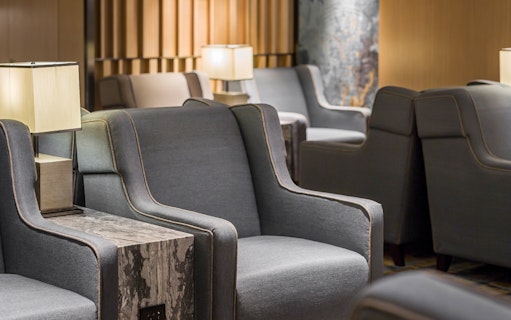 Seating area in Plaza Premium Lounge, Zone D, Taipei, Taiwan with armchairs and lamps.