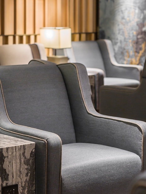 Seating area in Plaza Premium Lounge, Zone D, Taipei, Taiwan with armchairs and lamps.