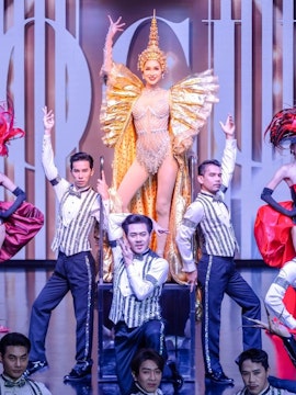 Calypso Cabaret performers in elaborate costumes on stage, Bangkok.