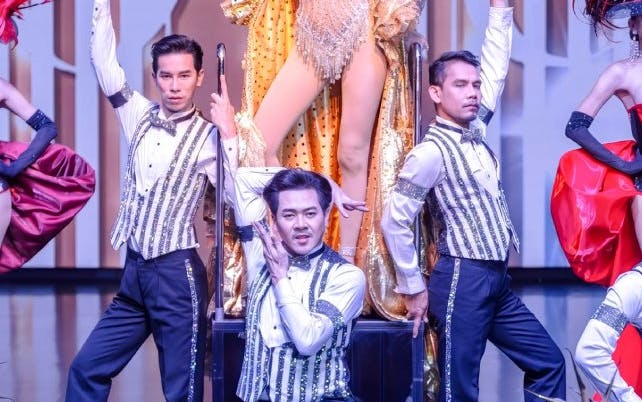 Calypso Cabaret performers in elaborate costumes on stage, Bangkok.