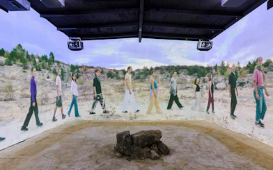 Guests viewing immersive desert landscape exhibit at Light Art Museum, Budapest.