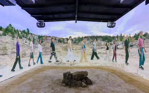 Guests viewing immersive desert landscape exhibit at Light Art Museum, Budapest.