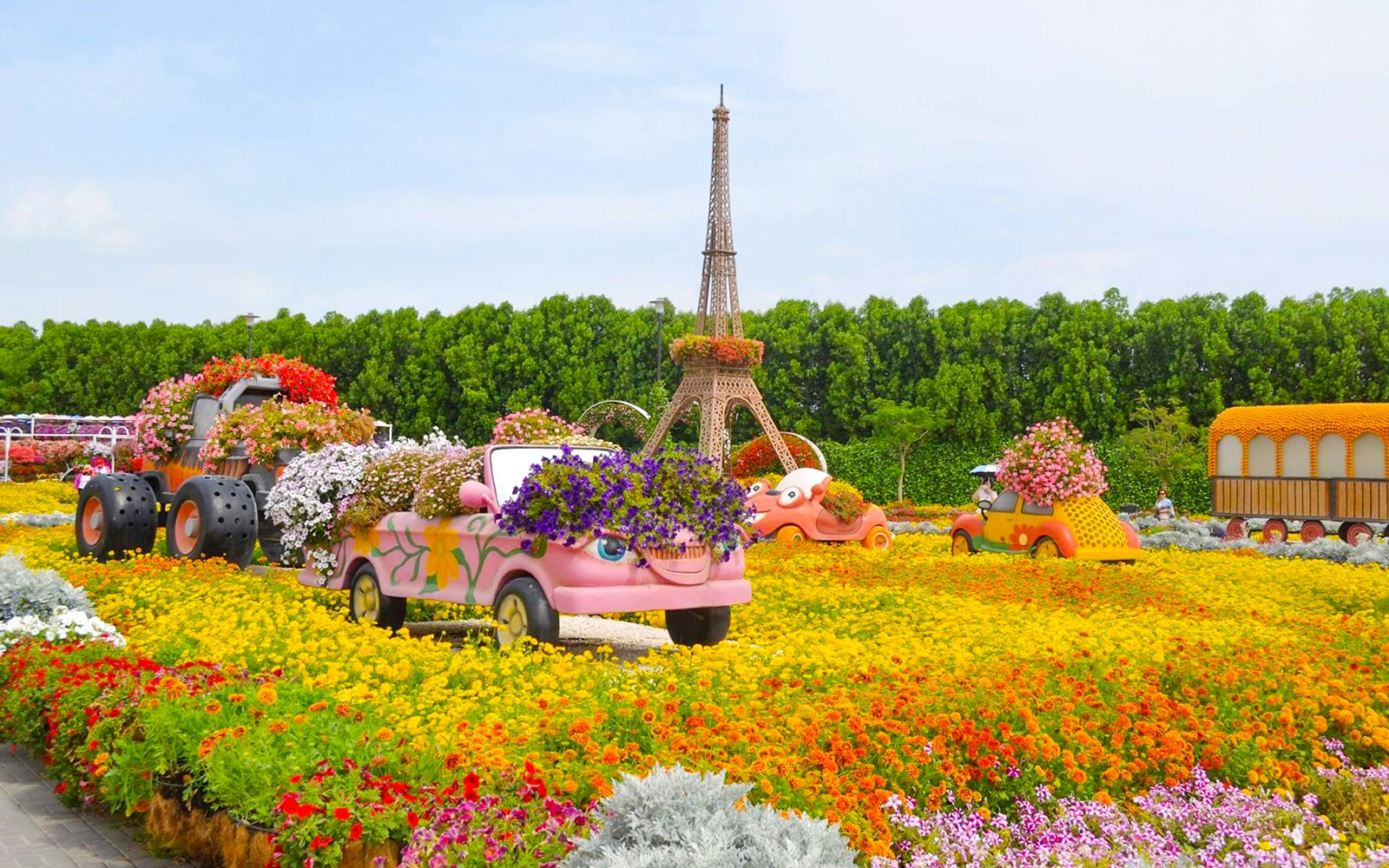 Floral car displays and Eiffel Tower replica at Miracle Gardens, Dubai.